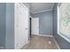 Bright bedroom with light-colored wood flooring, grey walls, and two white doors at 4325 Norwaldo Ave, Indianapolis, IN 46205