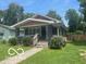Charming one-story home featuring a cozy front porch and a well-maintained lawn at 4325 Norwaldo Ave, Indianapolis, IN 46205