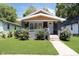 Charming bungalow-style home with a landscaped front yard and inviting entrance at 4325 Norwaldo Ave, Indianapolis, IN 46205