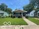 Charming bungalow-style home with a landscaped front yard and inviting entrance at 4325 Norwaldo Ave, Indianapolis, IN 46205