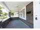 Inviting front porch with a gray painted floor and siding, and classic white trim at 4325 Norwaldo Ave, Indianapolis, IN 46205