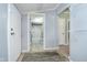 Hallway area with light-colored wood flooring, neutral paint, and views into the bathroom and other rooms at 4325 Norwaldo Ave, Indianapolis, IN 46205