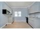 Bright kitchen features gray cabinets, granite countertops, stainless steel microwave, and hardwood floors at 4325 Norwaldo Ave, Indianapolis, IN 46205