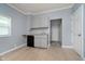 A compact kitchenette with gray cabinets, granite countertop, black dishwasher, and light wood flooring at 4325 Norwaldo Ave, Indianapolis, IN 46205