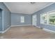 Inviting living room with wood flooring, large windows, and a front door at 4325 Norwaldo Ave, Indianapolis, IN 46205