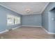 Bright living room boasts light-colored wood flooring, natural light, and a simple decorative ceiling light at 4325 Norwaldo Ave, Indianapolis, IN 46205