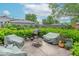 Outdoor backyard patio area with well-maintained privacy hedges, barbecue grill, and comfortable seating under covers at 445 N 13Th Ave, Beech Grove, IN 46107