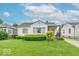 Well-maintained front lawn and tidy landscaping add to the curb appeal of this charming bungalow at 445 N 13Th Ave, Beech Grove, IN 46107