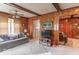 Cozy living room featuring wood paneled walls, comfortable seating, and open floorplan at 445 N 13Th Ave, Beech Grove, IN 46107