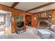 Comfortable living room featuring brick fireplace, wood accents, and seamless access to the kitchen at 445 N 13Th Ave, Beech Grove, IN 46107