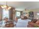 Bright living room with a decorative light fixture and glass-top dining table at 445 N 13Th Ave, Beech Grove, IN 46107