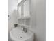 Cozy bathroom featuring a pedestal sink, medicine cabinet, and neutral color scheme at 5312 E Southern Ave, Indianapolis, IN 46203