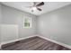 Bedroom with gray walls, laminate flooring, a white ceiling fan, and a window at 5312 E Southern Ave, Indianapolis, IN 46203