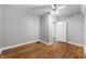 Bedroom with light-colored walls, hardwood floors, a closet, and a door leading to another room at 5312 E Southern Ave, Indianapolis, IN 46203