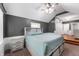 Bedroom with a sloped ceiling, an accent wall, carpeted floors, and an adjoining bathroom at 5312 E Southern Ave, Indianapolis, IN 46203