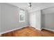 Empty bedroom with light-colored walls, hardwood floors, a ceiling fan, and a window at 5312 E Southern Ave, Indianapolis, IN 46203