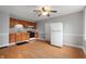 Bright kitchen features light-colored walls, wood cabinets, a white refrigerator, and a wood ceiling fan at 5312 E Southern Ave, Indianapolis, IN 46203