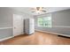 Bright kitchen with light-colored walls and laminate flooring featuring a window and a white refrigerator at 5312 E Southern Ave, Indianapolis, IN 46203