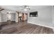 Spacious living room with hardwood floors, brick columns, and a modern ceiling fan at 5312 E Southern Ave, Indianapolis, IN 46203