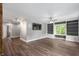Bright living room with hardwood floors, custom built-in shelving, and large window at 5312 E Southern Ave, Indianapolis, IN 46203