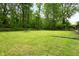 Spacious backyard with lush green lawn, mature trees, and ample space for recreation at 5422 Orange St, Indianapolis, IN 46203