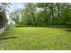 Expansive backyard with green lawn and trees, perfect for outdoor activities and relaxation at 5422 Orange St, Indianapolis, IN 46203