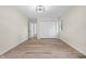 Empty bedroom featuring wood-look floors and white closet doors with access to additional rooms at 5422 Orange St, Indianapolis, IN 46203