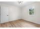 Unfurnished bedroom with updated flooring and natural light from the window at 5422 Orange St, Indianapolis, IN 46203