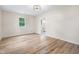 Empty bedroom featuring wood-look floors and white trim with access to a bathroom at 5422 Orange St, Indianapolis, IN 46203