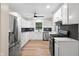 Well lit kitchen featuring stainless steel appliances, white cabinets and countertops, and wood-look floors at 5422 Orange St, Indianapolis, IN 46203