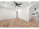 Open concept living room with hardwood floors, white walls and ceiling fan at 5422 Orange St, Indianapolis, IN 46203