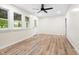 Spacious living room with new floors, ceiling fan, and nice windows at 5422 Orange St, Indianapolis, IN 46203