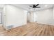 An empty living room with hard wood flooring, white walls, and a ceiling fan at 5422 Orange St, Indianapolis, IN 46203