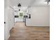 Open concept showing kitchen with stainless steel appliances and adjacent living room with wood-look floors at 5422 Orange St, Indianapolis, IN 46203