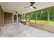 Inviting screened-in porch with concrete floors and ceiling fans for outdoor enjoyment and backyard views at 5422 Orange St, Indianapolis, IN 46203