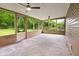 Inviting screened-in porch with concrete floors and ceiling fans for outdoor enjoyment and backyard views at 5422 Orange St, Indianapolis, IN 46203