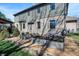 Rear exterior of home with landscaped garden beds and cozy patio at 545 Walnut Woods Dr, Greenwood, IN 46142