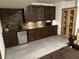 Basement wet bar features dark wood cabinets, stone backsplash, and stainless mini fridge at 545 Walnut Woods Dr, Greenwood, IN 46142
