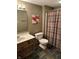 Bathroom features a tile floor, vanity with sink, toilet, and shower with a curtain at 545 Walnut Woods Dr, Greenwood, IN 46142