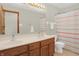 Bright bathroom features a double sink vanity, large mirror, and a striped shower curtain at 545 Walnut Woods Dr, Greenwood, IN 46142