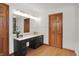Bathroom vanity area with dual sinks, black cabinets, and lots of storage space at 545 Walnut Woods Dr, Greenwood, IN 46142