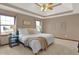 Inviting bedroom featuring tray ceilings, large windows, and comfortable decor at 545 Walnut Woods Dr, Greenwood, IN 46142