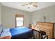 Cozy bedroom with a comfortable bed, wooden desk, and natural light from the window at 545 Walnut Woods Dr, Greenwood, IN 46142