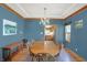 Bright dining room with wood table, chandelier, and view of the adjacent kitchen at 545 Walnut Woods Dr, Greenwood, IN 46142