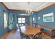 Elegant dining room featuring a wooden table, chandelier lighting, and blue walls at 545 Walnut Woods Dr, Greenwood, IN 46142