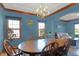 Stylish dining room featuring a wood table, chandelier, and large windows with natural light at 545 Walnut Woods Dr, Greenwood, IN 46142