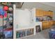 Garage dog wash station equipped with a shower and shelving for pet care supplies at 545 Walnut Woods Dr, Greenwood, IN 46142