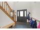 Inviting foyer with wooden staircase, slate flooring, and ample natural light at 545 Walnut Woods Dr, Greenwood, IN 46142