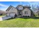 Charming two-story brick home with an attached three-car garage and well-manicured lawn at 545 Walnut Woods Dr, Greenwood, IN 46142