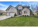 An attractive two-story brick home boasts a three-car garage and a lush green lawn at 545 Walnut Woods Dr, Greenwood, IN 46142